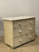 A small Victorian white painted pine chest fitted with two short and three long drawers on stile