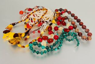 A collection of bead necklaces to include two yoke and clear honey coloured amber necklaces L x 25