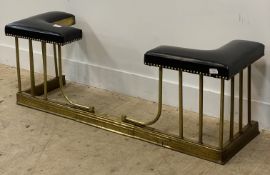 An Edwardian telescopic brass club fender with faux leather seat to each end. H50cm, W135cm.