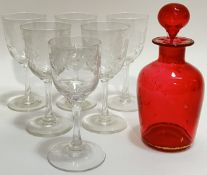 A gilt cranberry glass bottle (h- 15cm) together with five fruit and vine engraved stem glasses, and
