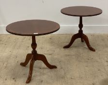 A pair of reproduction cross banded mahogany circular occasional tables, each top raised on triple