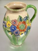 A Scottish Pottery jug by Mary L Fairgrieve of Ayreshire of oviform shape painted with spring
