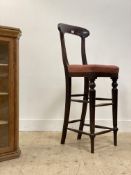 A mahogany clerks chair, early to mid 19th century, the shaped crest rail above an upholstered seat,