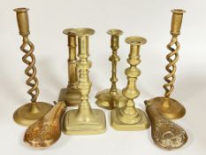 A group of brassware comprising six candlestick holders (largest h- 28cm), and two embossed powder