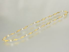 A continental yellow metal oval filigree link chain necklace with mounted with ten cultured pearl