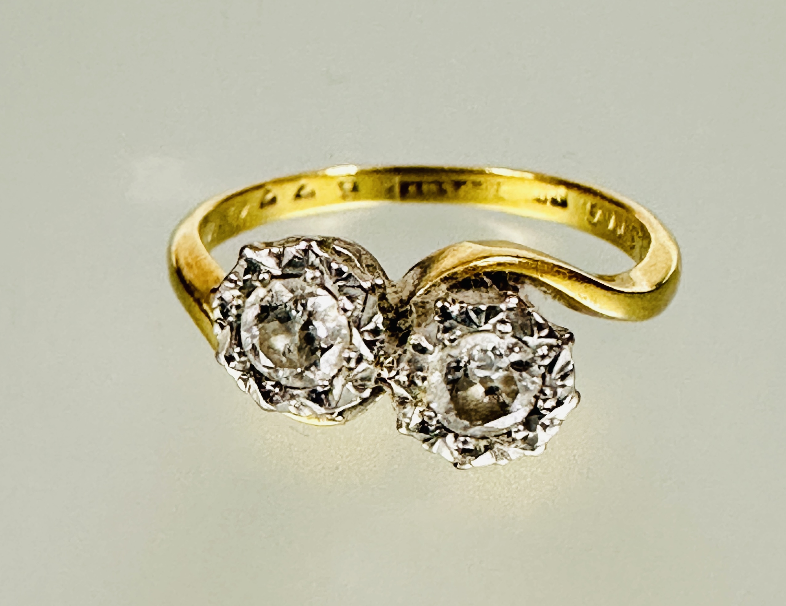 A 18ct gold platinum set toi-et moi diamond ring mounted in rub-over setting each stone