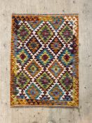 A Chobi kilim flatweave rug of geometric design. 115cm x  85cm .