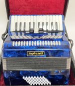 A blue Stephanelli 48 bass accordion accompanied by a fitted hard case