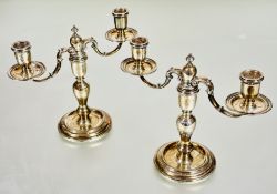 A pair of Mappin & Webb London silver Georgian style baluster stem twin branch candelabrum with