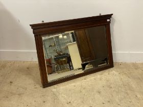 An Edwardian walnut framed over mantel mirror with bevelled edge. 68cm x 105cm.