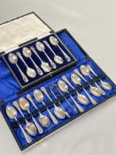 A cased set of six Epns thistle engraved and pierced tea spoons and a cased set of eleven plus one