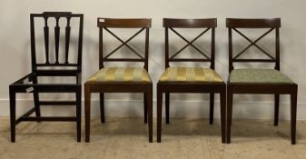 A set of three early 19th century mahogany dining chairs, with crossed back rests, drop in seat pads