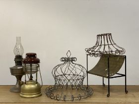A group lot, comprising two wirework planters, a tilley lamp and an oil lamp, a brass and wrought