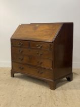 A Georgian mahogany bureau, the fall front opening to a fitted interior above two short and three