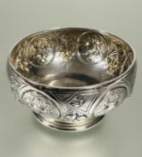 A Victorian Birmingham silver sugar bowl of circular tapered form with four chased floral panels and