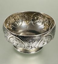 A Victorian Birmingham silver sugar bowl of circular tapered form with four chased floral panels and