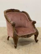 A Victorian style walnut framed miniature upholstered armchair, with floral carved show frame and