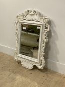 A white painted wall haning mirror, the frame composed of scroll carved acanthus leaves 80cm x 60cm