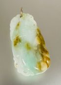 A eastern modern celadon mottled and russet jade gourd pendant with carved scrolling leaves and