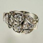 A Edwardian white metal buckle cocktail ring set two round old cut diamonds approximately 0.4ct each