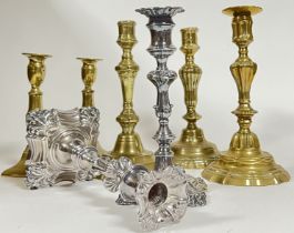 A group of candlestick holders including five brass, and a pair of silver plated (largest h- 25.5cm)
