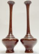 A pair of Japanese bronze vases of squat form with tapering slender necks and flared mouth (h-