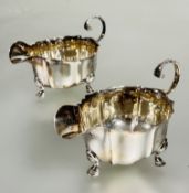 A pair of modern Mappin & Webb Sheffield silver Georgian style fluted sauce boats with S scroll