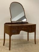 A 1930's mahogany dressing table, with swing mirror above a long drawer and four short drawers,