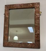 An Art and Crafts period, copper hammered finished decorative mirror. (54cmx63cm)