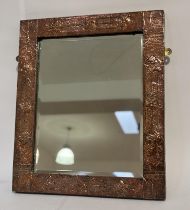 An Art and Crafts period, copper hammered finished decorative mirror. (54cmx63cm)