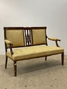 An Edwardian inlaid mahogany drawing room sofa, upholstered in golden damask, raised on square