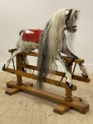 A Vintage Dapple gray rocking horse, early to mid 20th century, with horse hair mane and moving on a