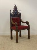 A Gothic revival oak ecclesiastical throne chair, late 19th century, the arched crest rail with