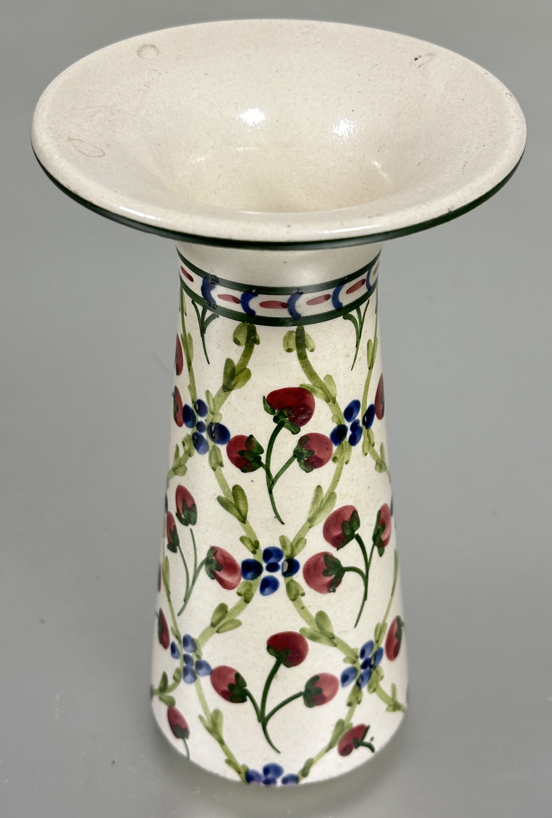 A Arts and Crafts Liberty of London flared neck tapered cylinder vase decorated with lattice leaf
