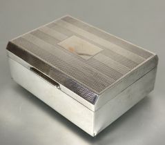 A London silver cigarette box with engine turned decoration and cedar lined interior marks rubbed
