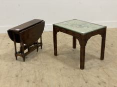 A mahogany coffee table, the glazed top inset with embroidered panel worked in a floral design and