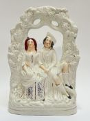 A large Staffordshire pottery figural group of a couple under a bough (some cracks, h- 36cm, w-