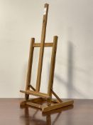 A beech framed table top folding easel. H77cm.