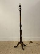 A 1920's mahogany standard lamp in the Georgian style, standing on three splayed supports with