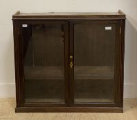 An Edwardian glazed mahogany two door cabinet fitted with two shelves. H89cm, W95cm, D28cm.
