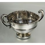 A Edwardian London silver twin C scroll handle rose bowl with plain border raised on circular
