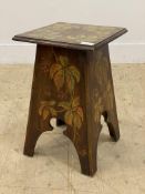 An early 20th century end table, the square top and splayed and fret carved panel end supports all