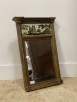 A Regency gilt framed pier glass mirror, inset with verre eglomise panel depicting monastic ruins (