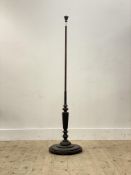 A well turned mahogany lamp standard, early 20th century, the water leaf carved finial above a