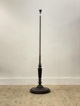 A well turned mahogany lamp standard, early 20th century, the water leaf carved finial above a