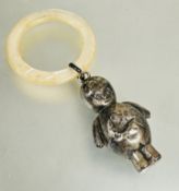 A Edwardian silver childs standing figure rattle with mother of pearl teething ring shows signs of