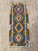 A Chobi kilim flat weave runner rug of characteristic design 148cm x 63cm