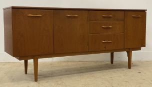 J.S. Furniture of Glasgow, A mid century teak sideboard, fitted with twin doors enclosing a shelf,