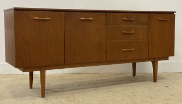 J.S. Furniture of Glasgow, A mid century teak sideboard, fitted with twin doors enclosing a shelf,