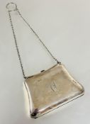A Edwardian Birmingham silver evening purse of shaped form with chain handle and engraved initials
